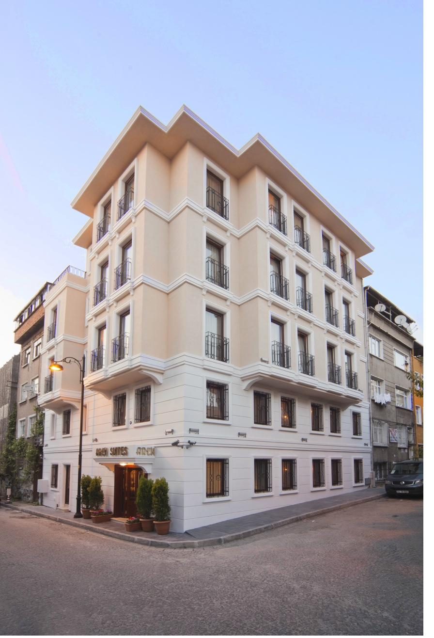 Aren Suites building exterior at twilight with warm lighting