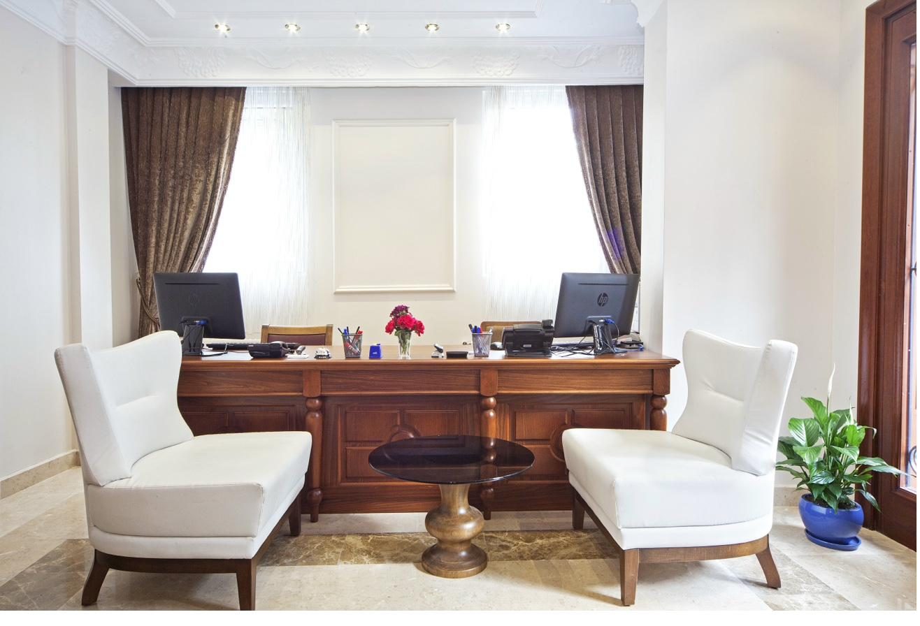 Lobby lounge with leather armchairs and wooden reception