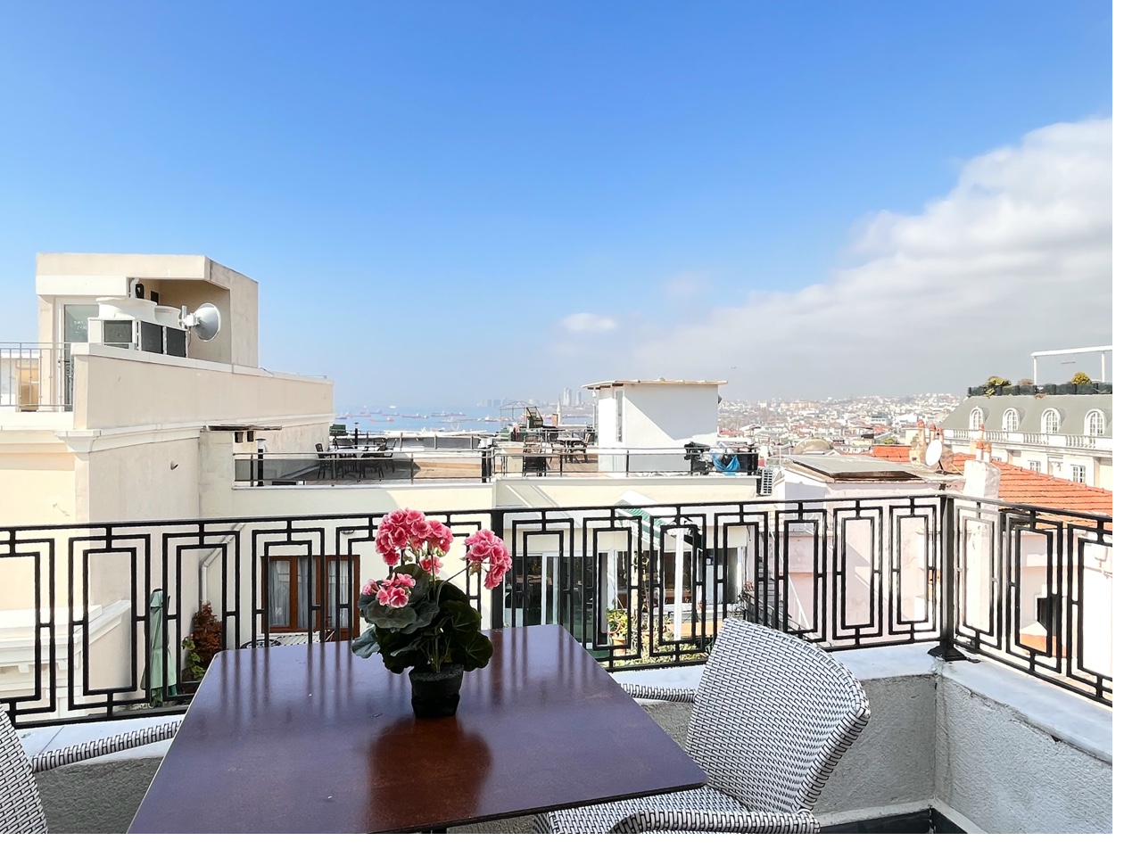 Balcony dining table with flowers and city panorama