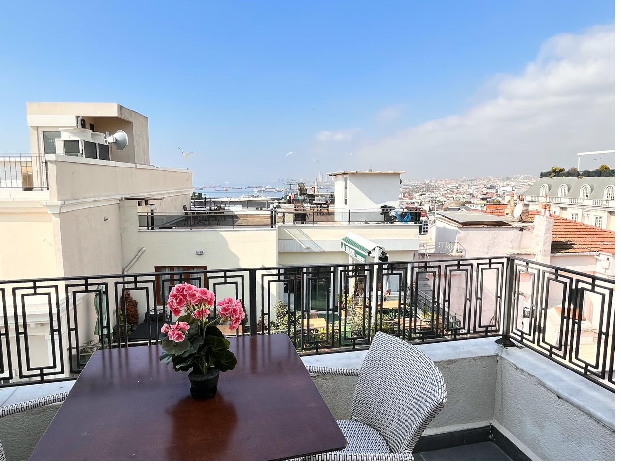 Wide angle balcony with sea panorama and outdoor furniture