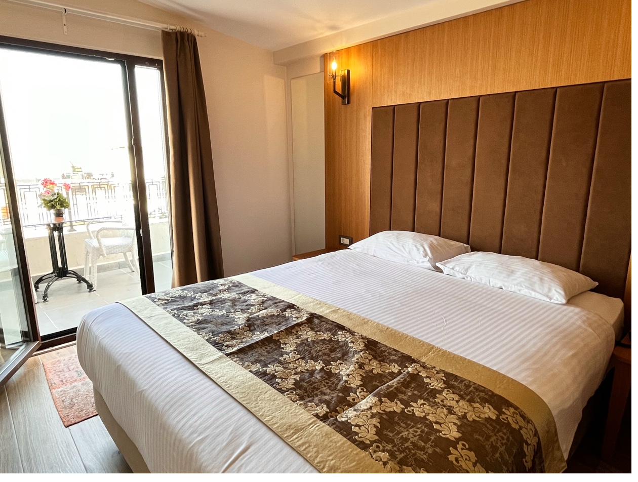 Balcony Sea View Room with open balcony door and sea glimpse