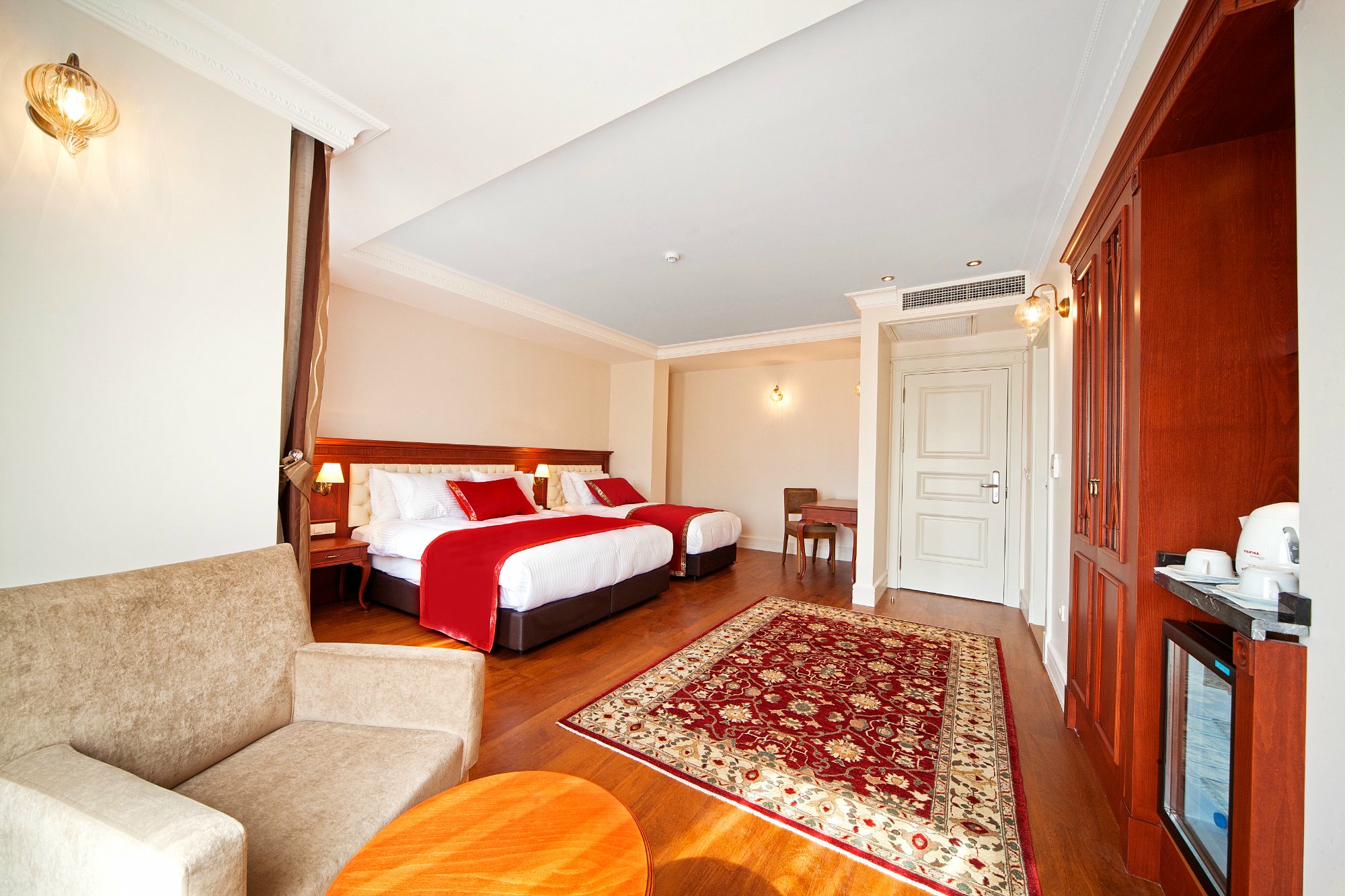 Superior Quadruple Room wide view with carpet and furniture