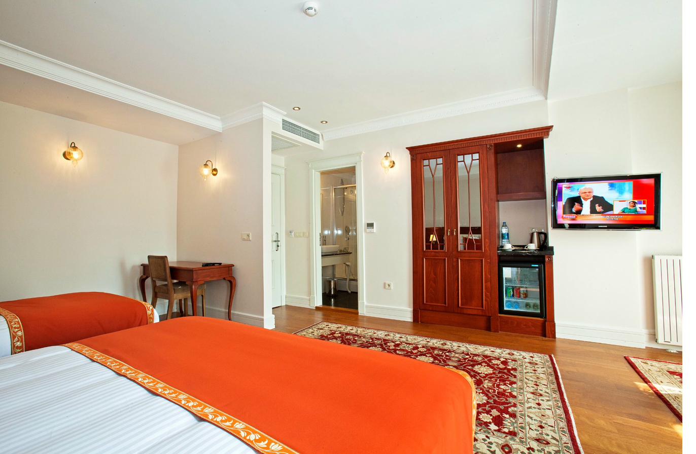 Superior Quadruple Room bed detail with decorative accents