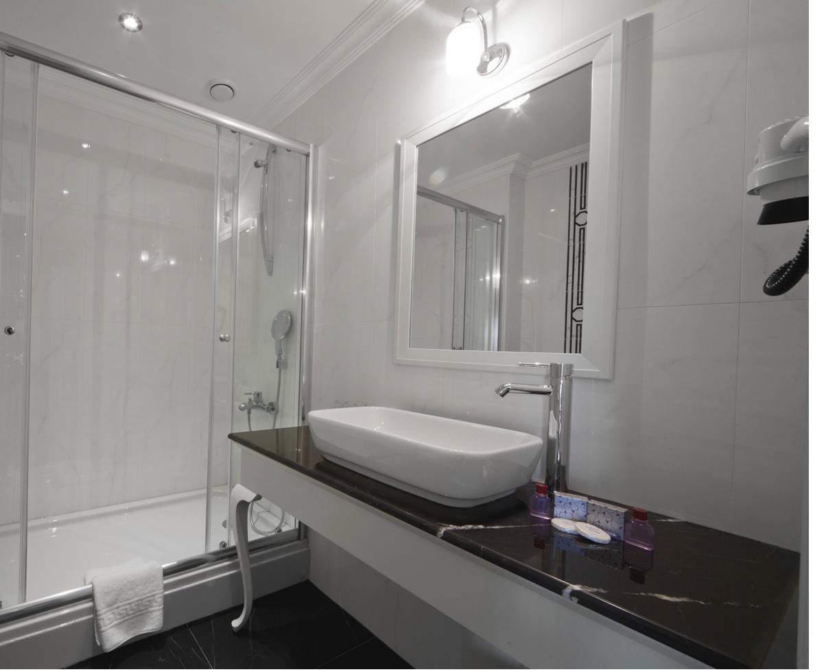 Standard Double Room bathroom wide angle with shower and sink